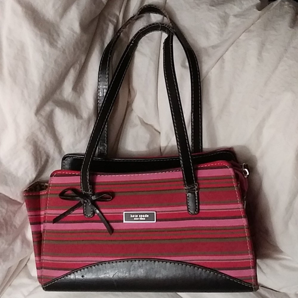 Little Kate Spade purse somewhere on the handles